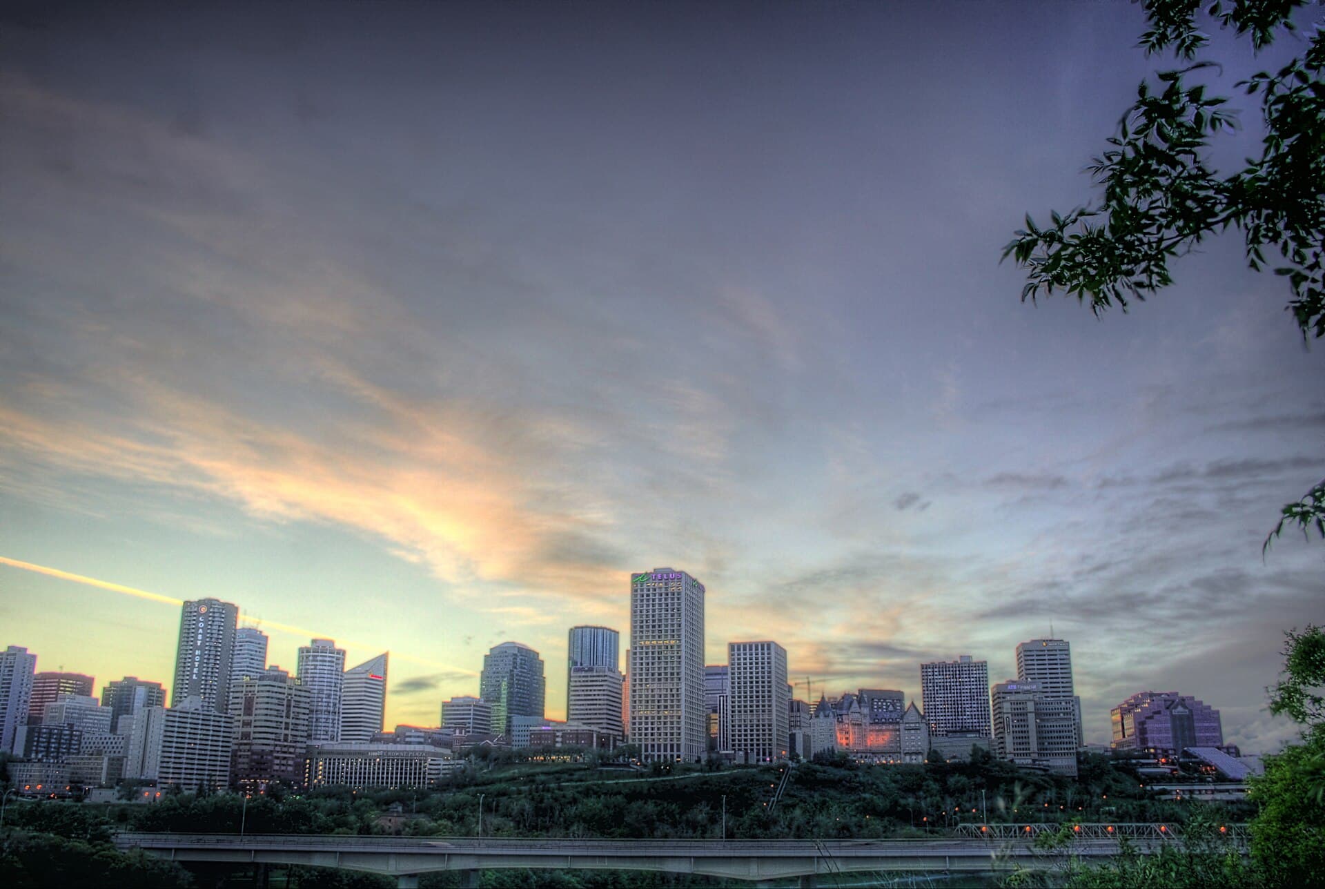Downtown Edmonton skyline above the North Saskatchewan River valley at dusk
