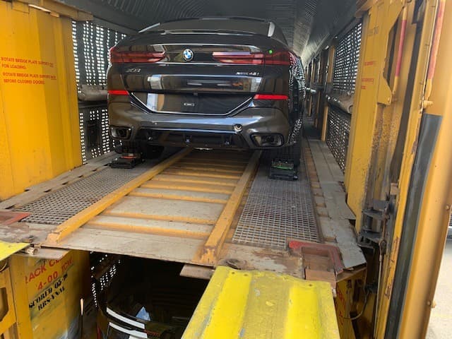 A customer's BMW X6 secured inside a fully enclosed autorack rail car for rail transport