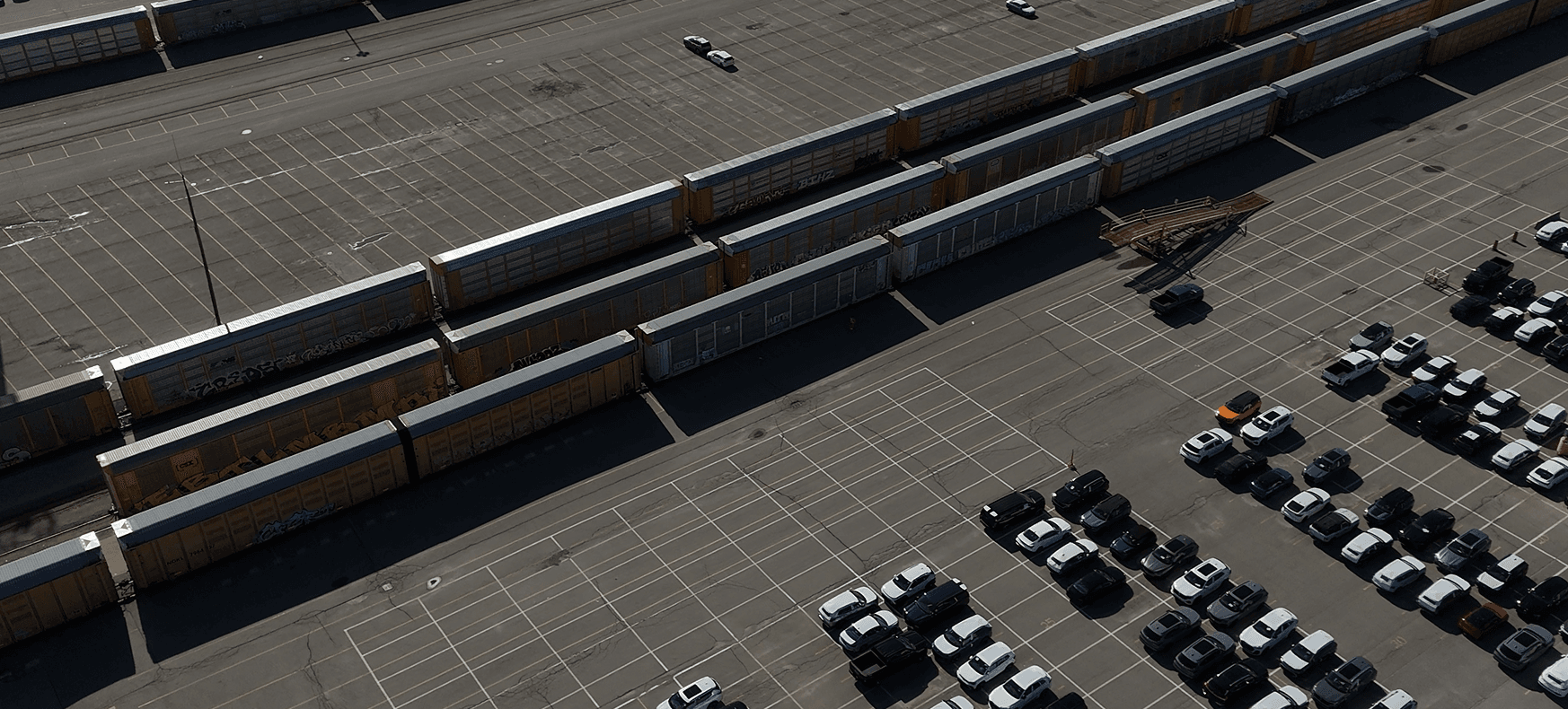 Aerial view of autorack trains and staged vehicles at the CN rail yard in Vaughan, Ontario